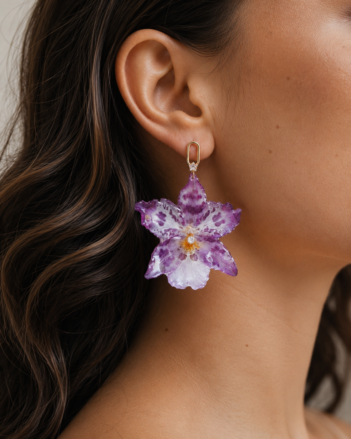 Model wearing speckled purple leopard orchid drop earrings with a gold-tone geometric stud, Leopard Orchid Drop Earrings botanical jewellery by Terra Decode