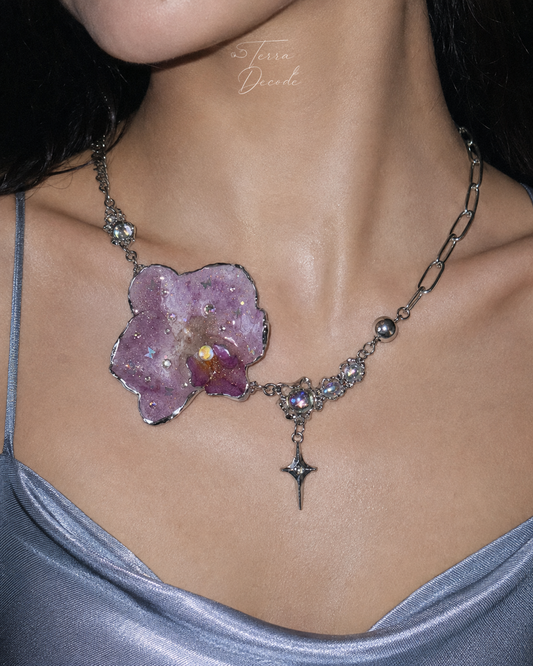Model wearing the Lilac Phalaenopsis Moonstone Star-Drop Necklace from Terra Decode's Flowers in Y2K collection