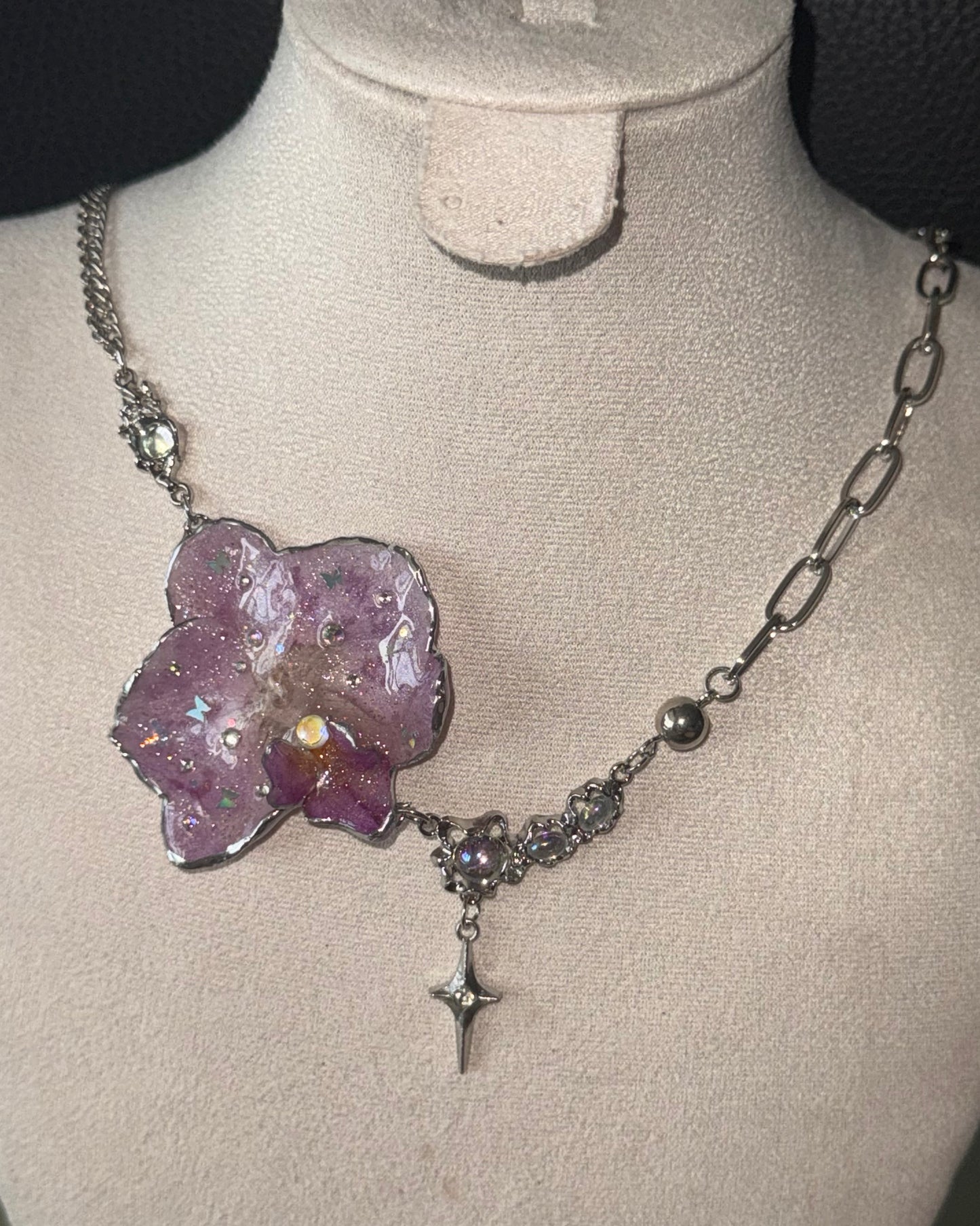Lilac phalaenopsis preserved-flower necklace with mixed silver-toned chains shown from the front