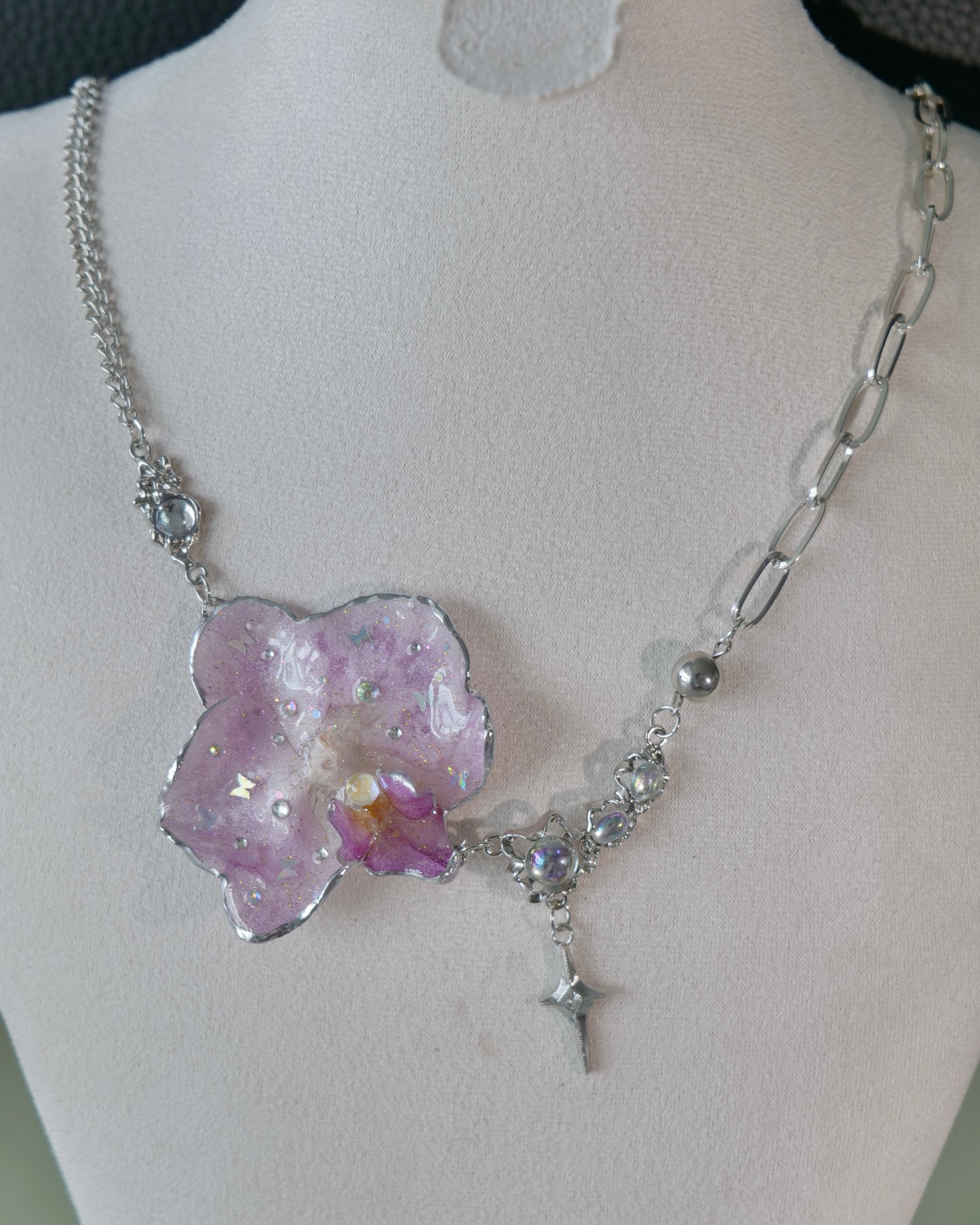 Natural-light view of lilac orchid necklace with moonstone accent and star drop