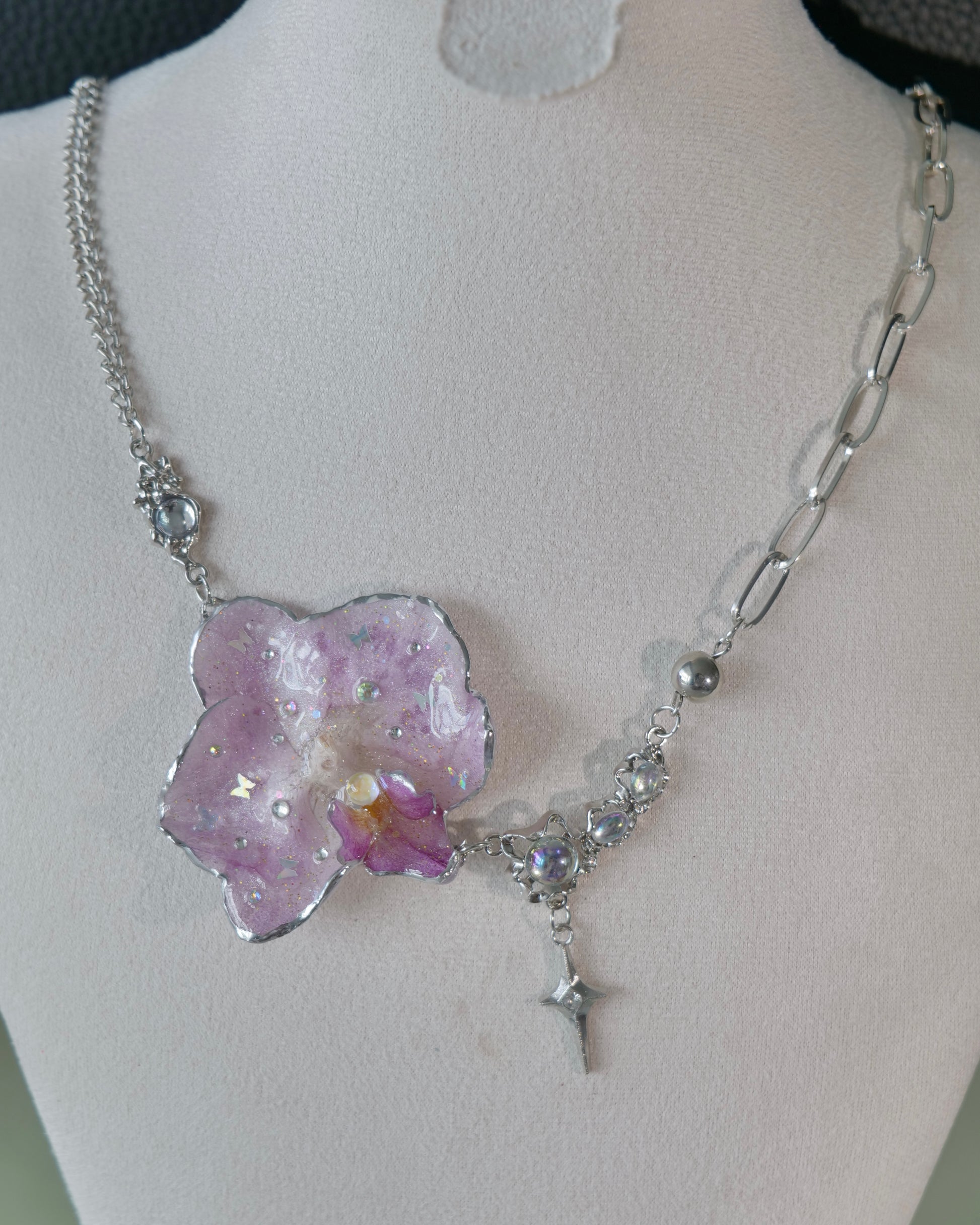Natural-light view of lilac orchid necklace with moonstone accent and star drop