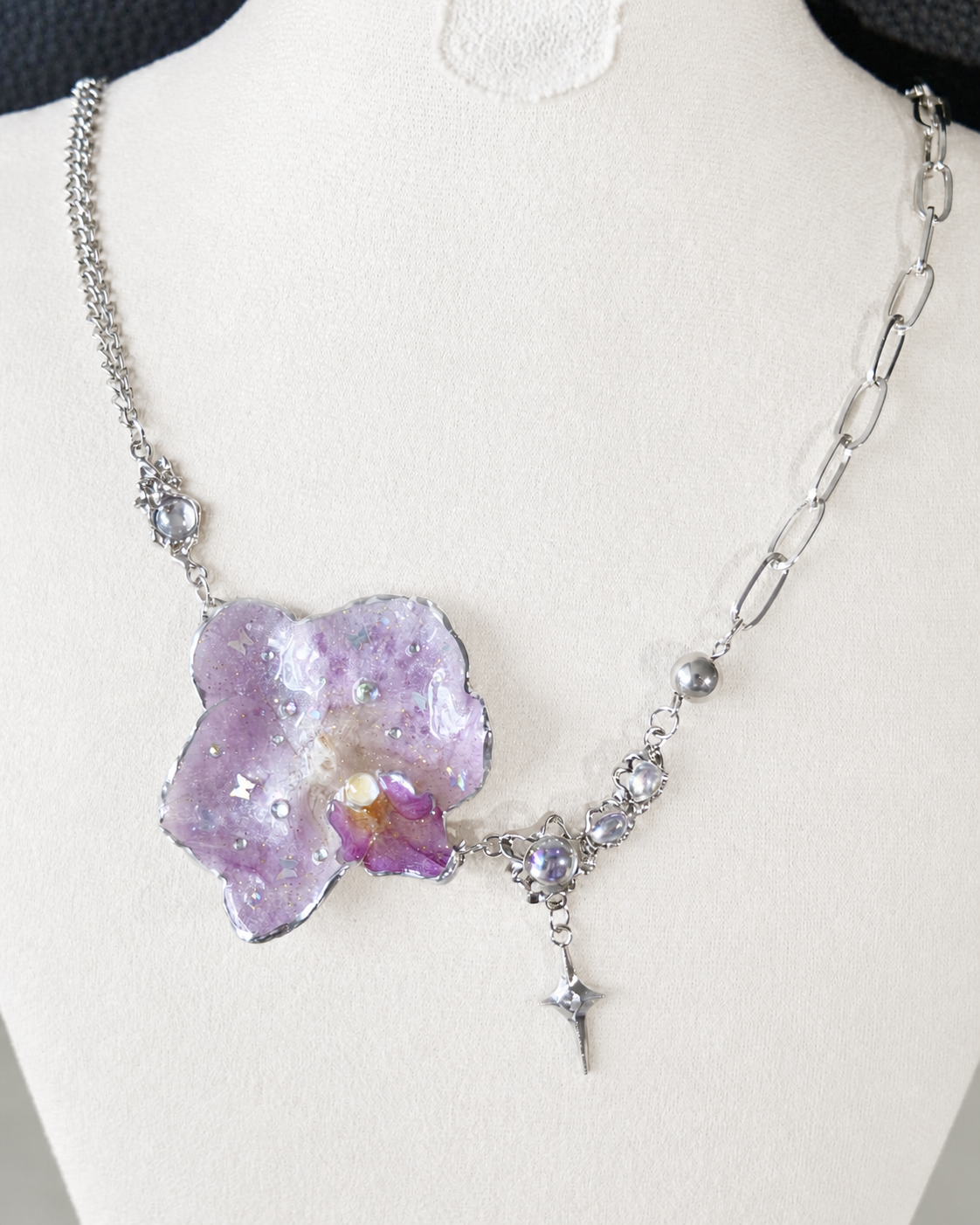 Full display view showing mixed silver-toned chains and the star-shaped drop, Lilac Phalaenopsis Moonstone-Style Star-Drop Necklace botanical jewellery by Terra Decode