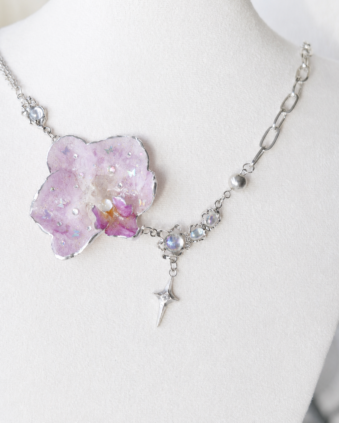 Alternate angle of the lilac orchid pendant and moonstone-style accents, Lilac Phalaenopsis Moonstone-Style Star-Drop Necklace botanical jewellery by Terra Decode