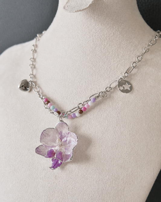 Close view of the real Phalaenopsis orchid preserved in clear resin, Lilac Phalaenopsis Pastel Bead Charm Necklace botanical jewellery by Terra Decode