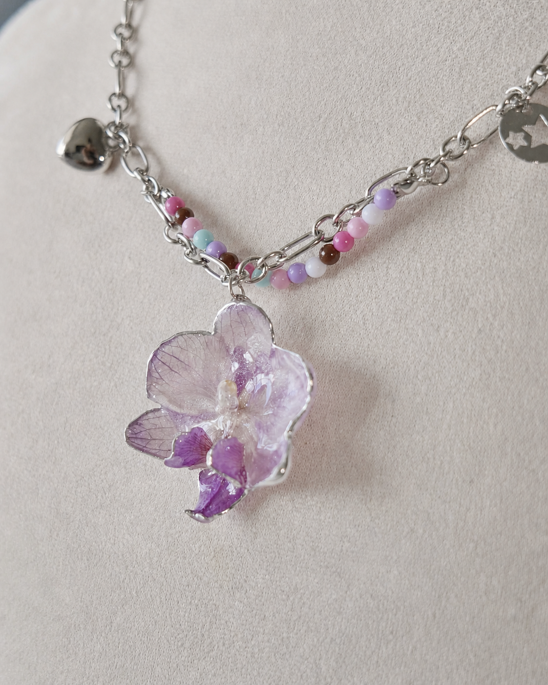 Full display view showing the pastel beads and layered silver-toned chain, Lilac Phalaenopsis Pastel Bead Charm Necklace botanical jewellery by Terra Decode