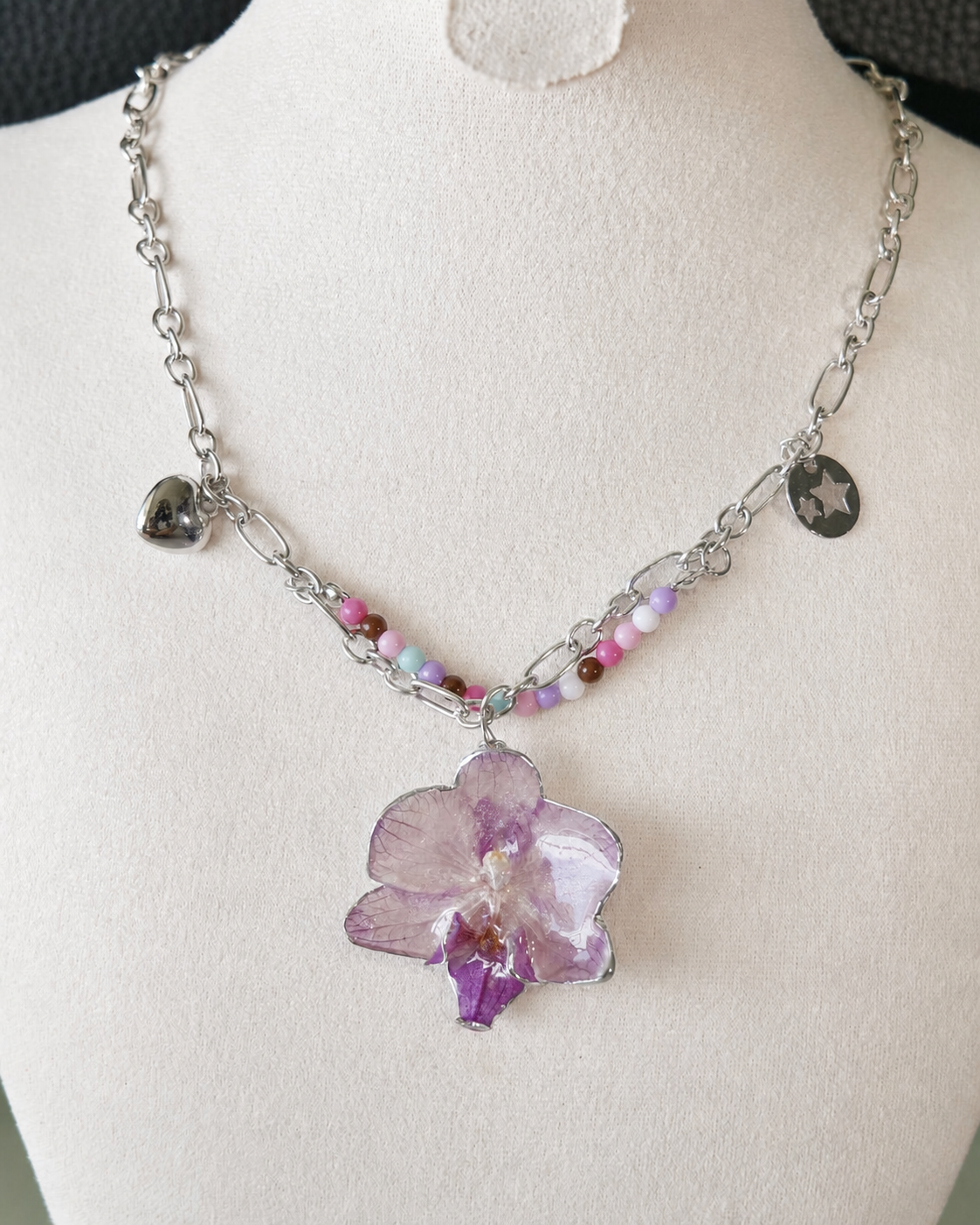 Alternate angle of the lilac orchid pendant and playful Y2K charms, Lilac Phalaenopsis Pastel Bead Charm Necklace botanical jewellery by Terra Decode