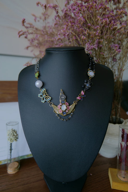 Front view of Nandina leaf necklace with asymmetric black and silver-toned chain