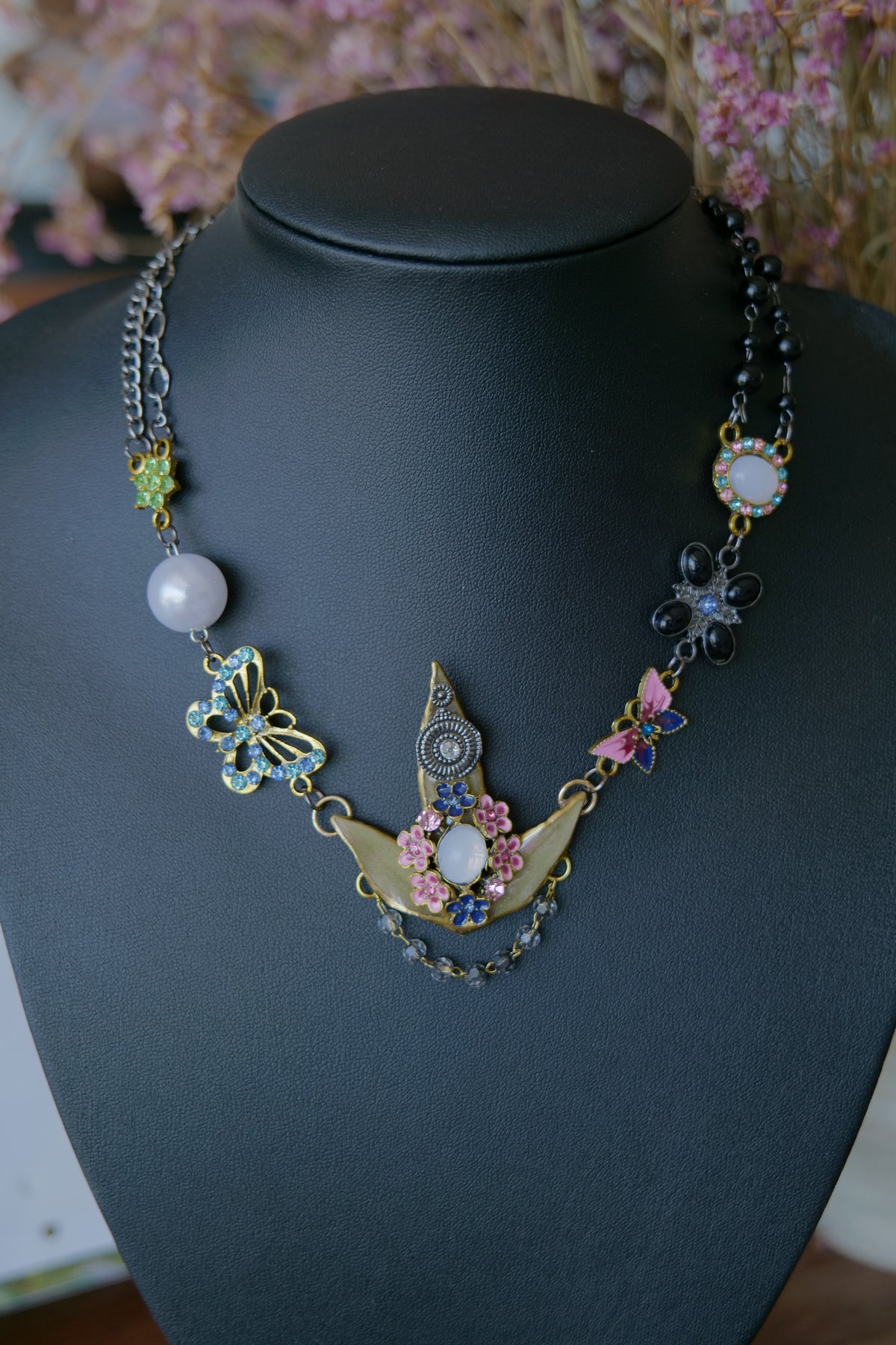 Mixed black and silver-toned chain and charm details on the Nandina necklace