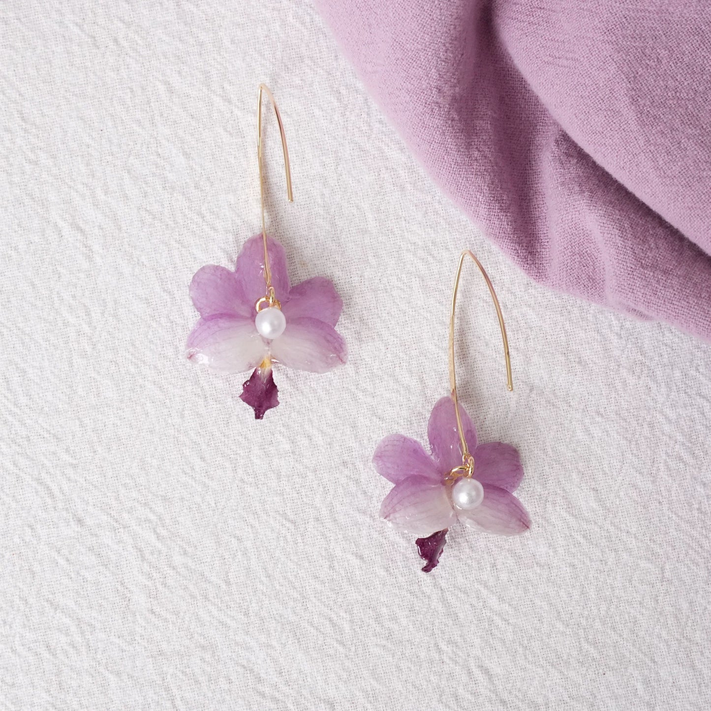 Soft Purple orchid earrings with resin petals and long gold-tone ear hooks by Terra Decode