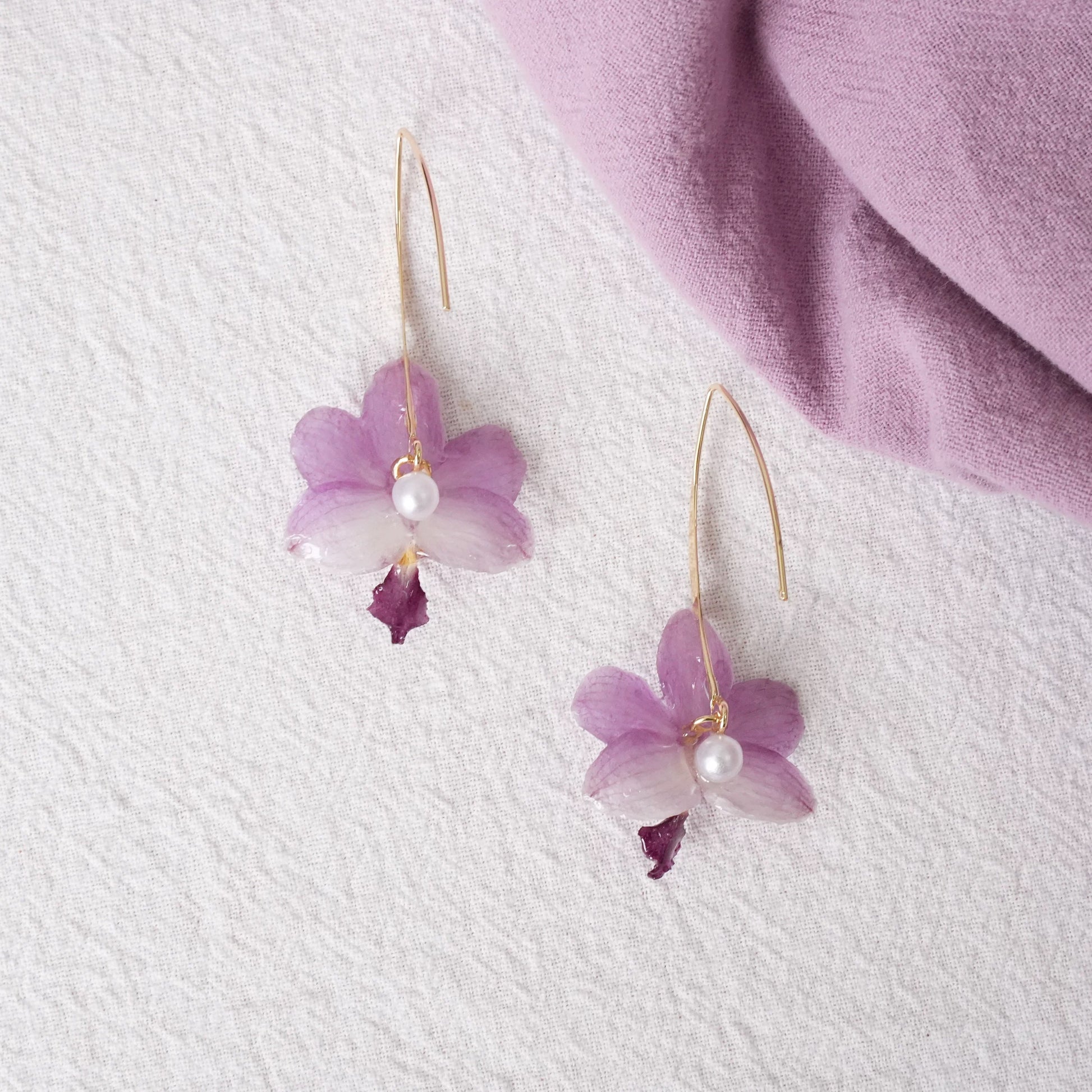 Soft Purple orchid earrings with resin petals and long gold-tone ear hooks by Terra Decode