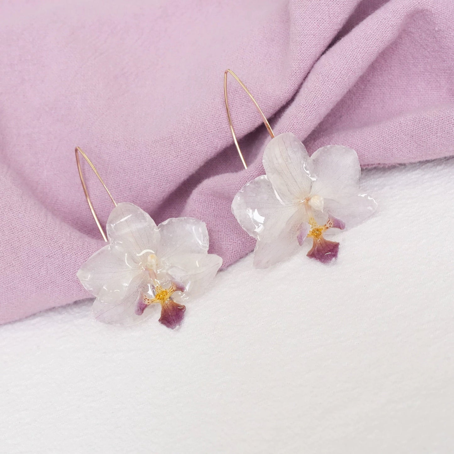 Cream White orchid earrings with resin petals and long gold-tone ear hooks by Terra Decode