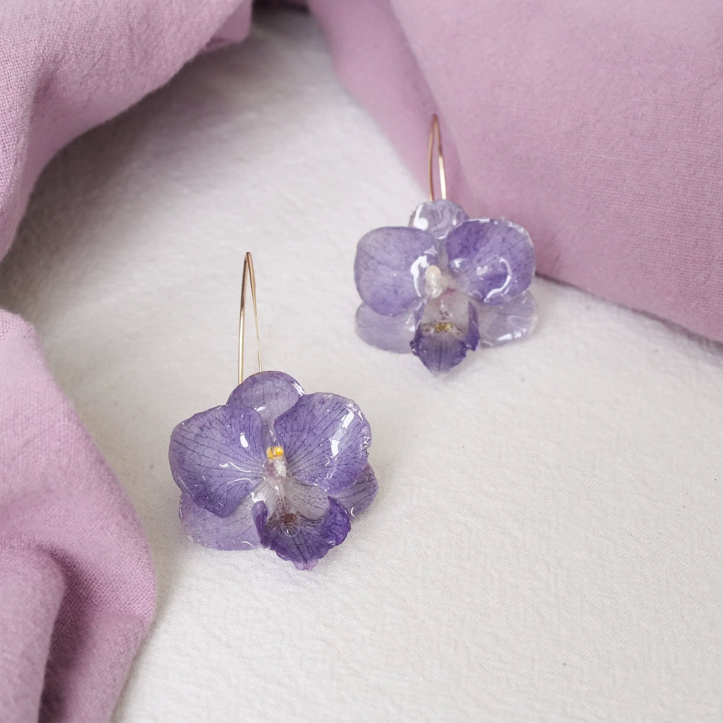 Blue Lavender orchid earrings with resin petals and long gold-tone ear hooks by Terra Decode