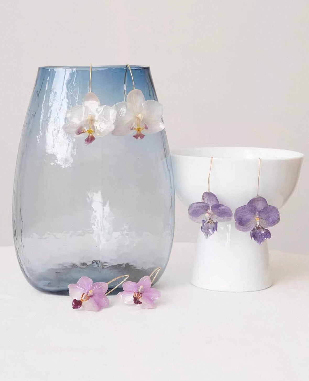 Cream white, blue lavender and soft pink orchid ear hook earrings with resin petals by Terra Decode