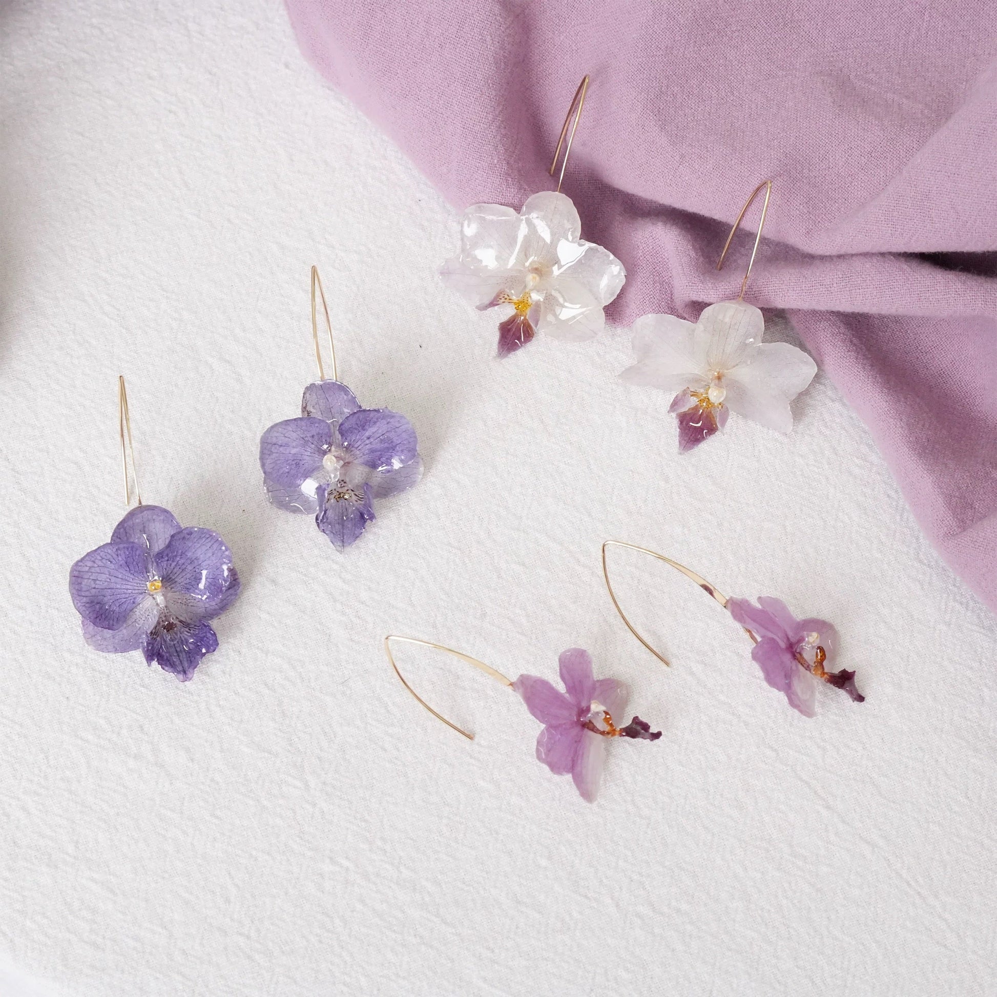 Orchid ear hook earring variations with cream white, blue lavender and soft pink resin petals by Terra Decode