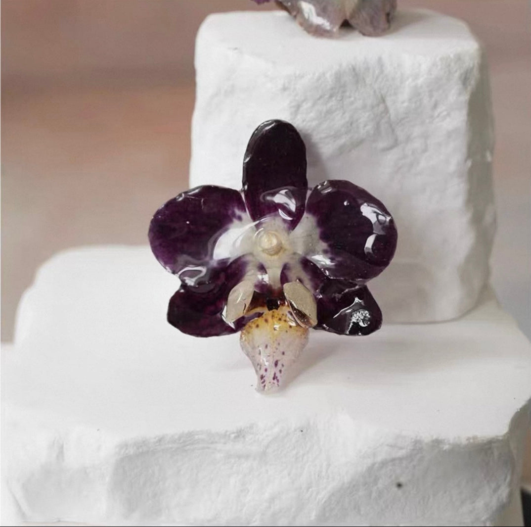 Deep Plum orchid brooch with resin flower petals and glossy finish by Terra Decode