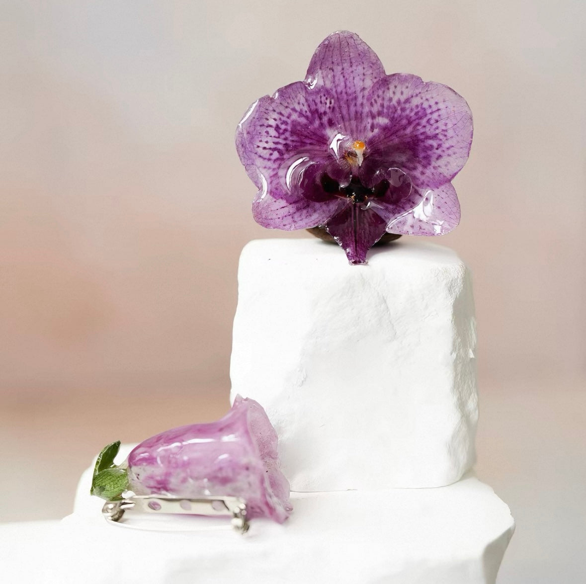 Deep purple orchid brooch with resin petals on a plaster display by Terra Decode