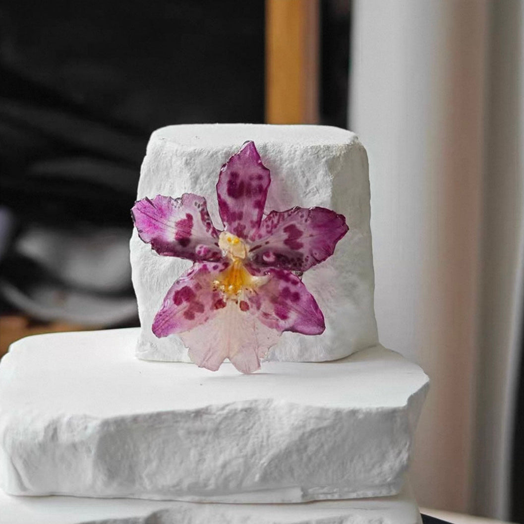 Soft purple orchid brooch with resin petals shown close-up on display by Terra Decode