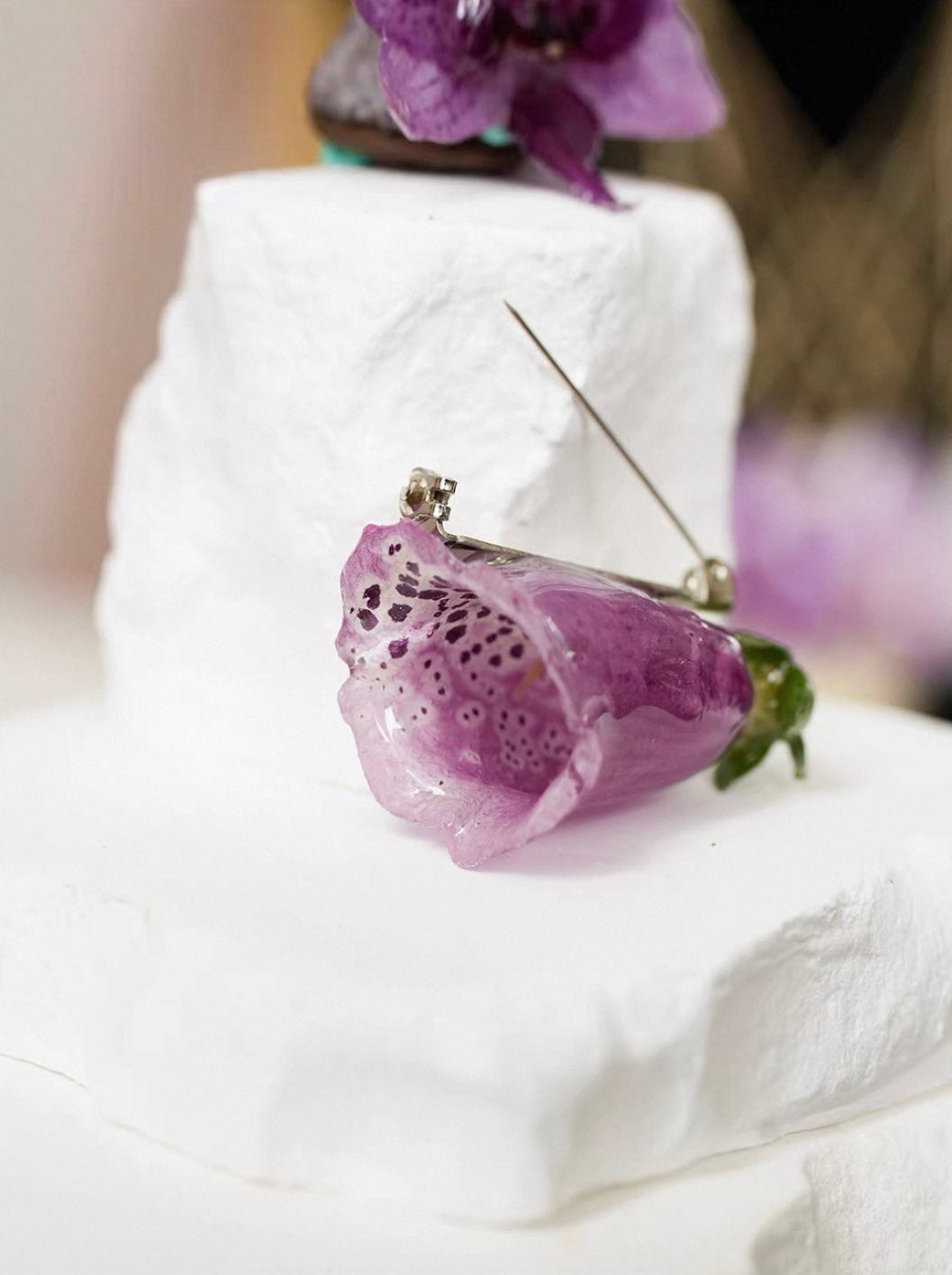 Speckled purple orchid brooch with resin petals and visible pin structure by Terra Decode