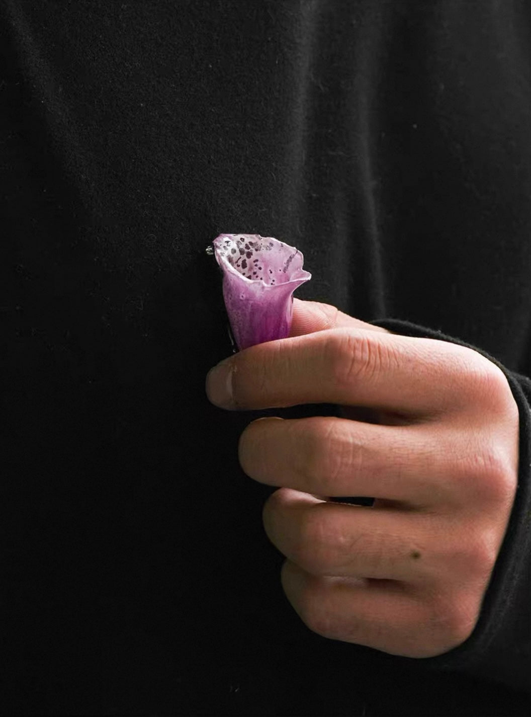 Soft purple orchid brooch with resin petals shown in side view against black fabric by Terra Decode