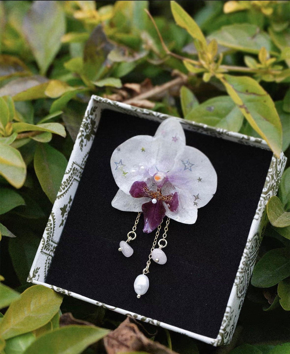 White pearl detail orchid brooch with resin petals displayed in a presentation box by Terra Decode