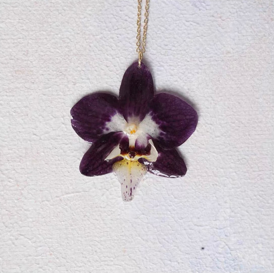Deep Plum orchid necklace with resin flower pendant and gold-tone chain by Terra Decode