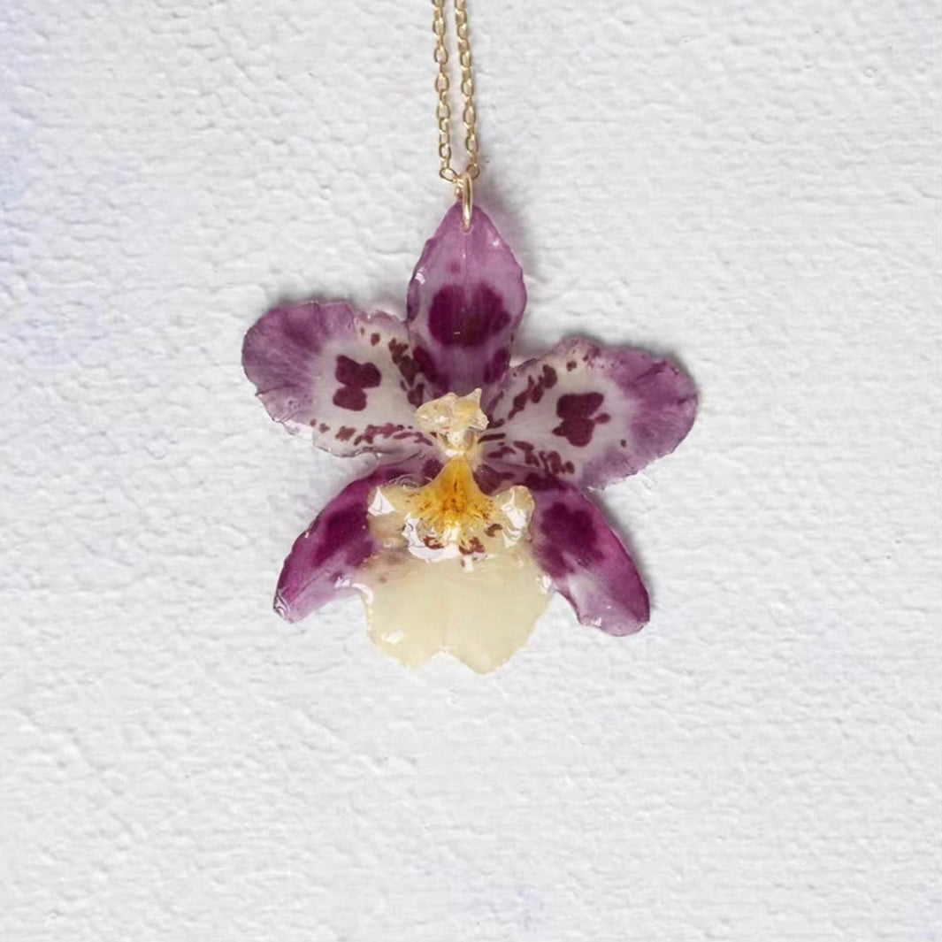 Speckled Purple orchid necklace with resin flower pendant and gold-tone chain by Terra Decode
