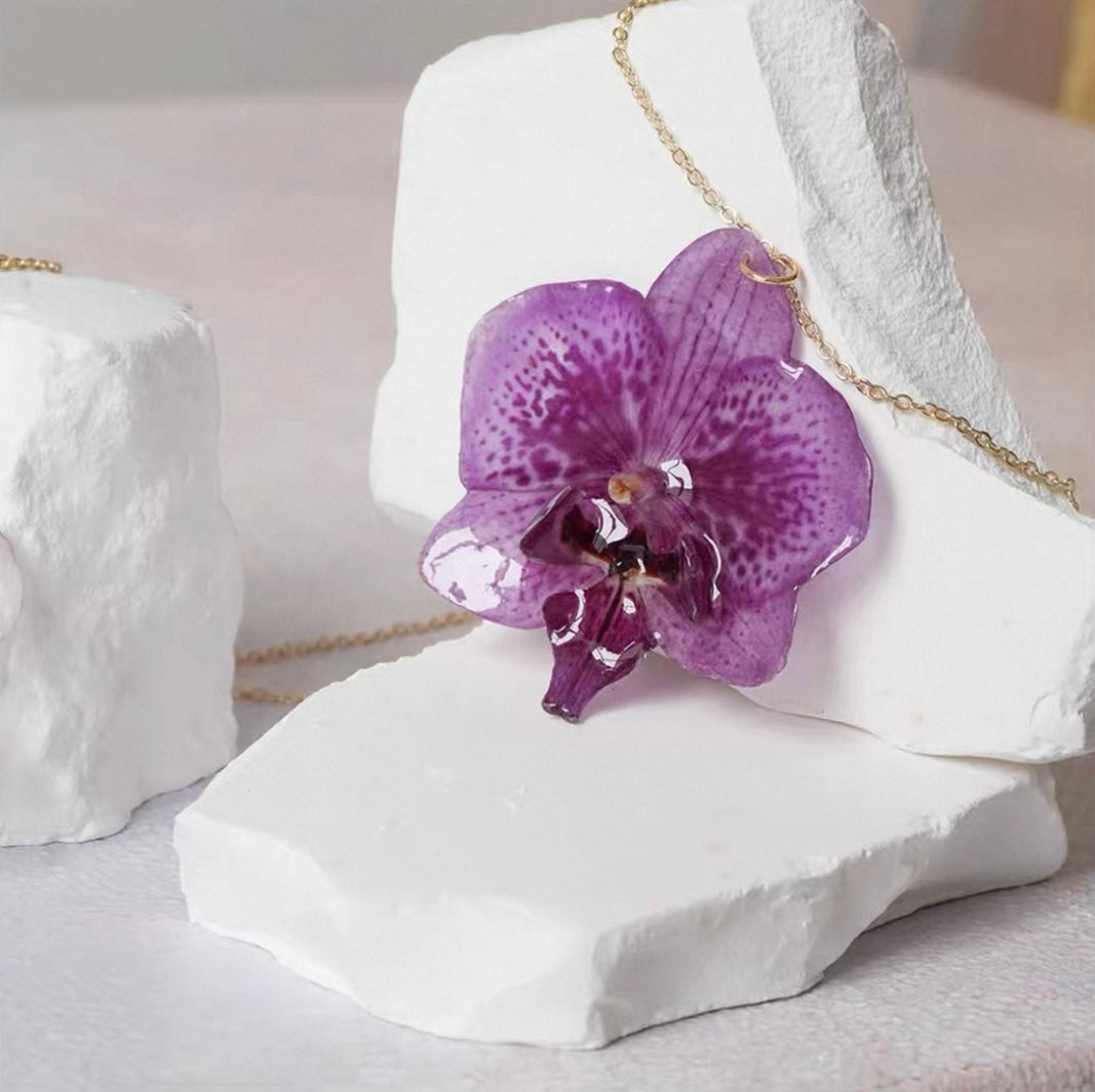 Soft purple orchid necklace with resin flower pendant and sculptural styling by Terra Decode