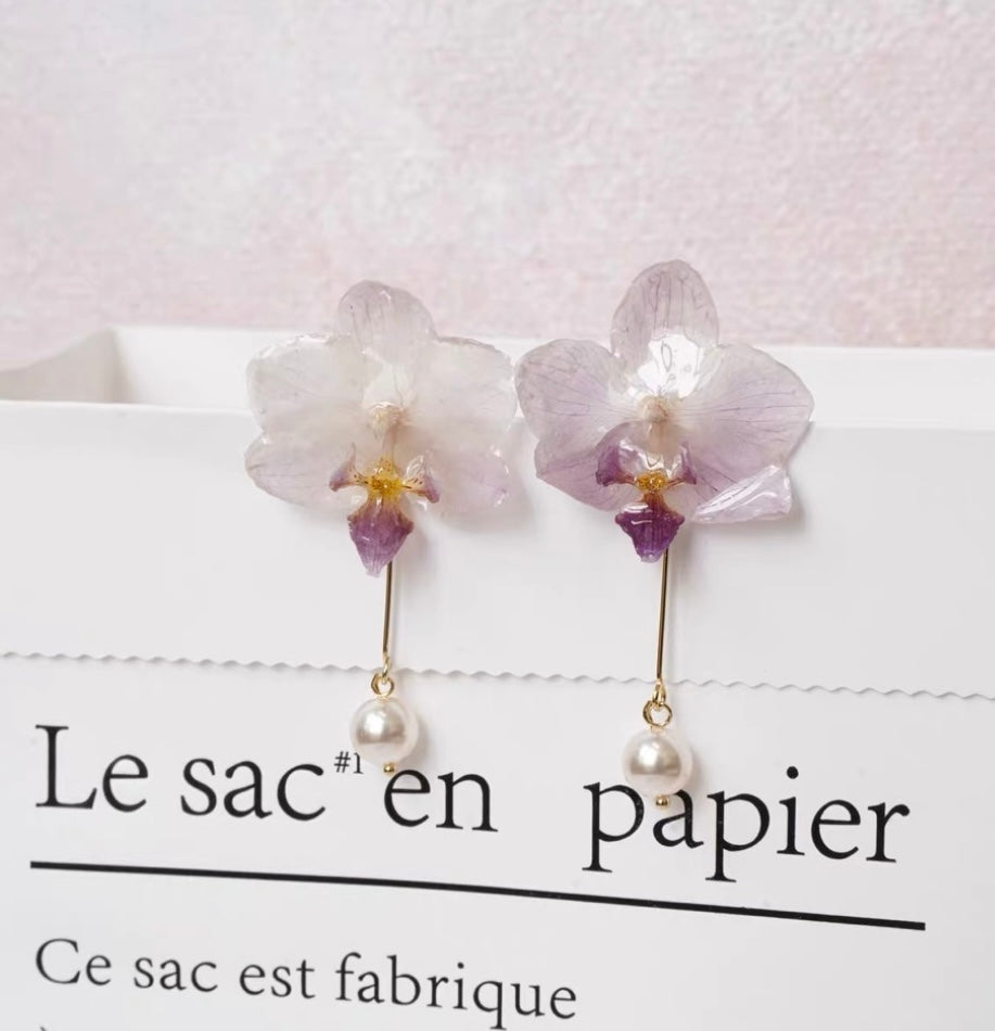 Cream White orchid earrings with resin petals and pearl-like drop by Terra Decode
