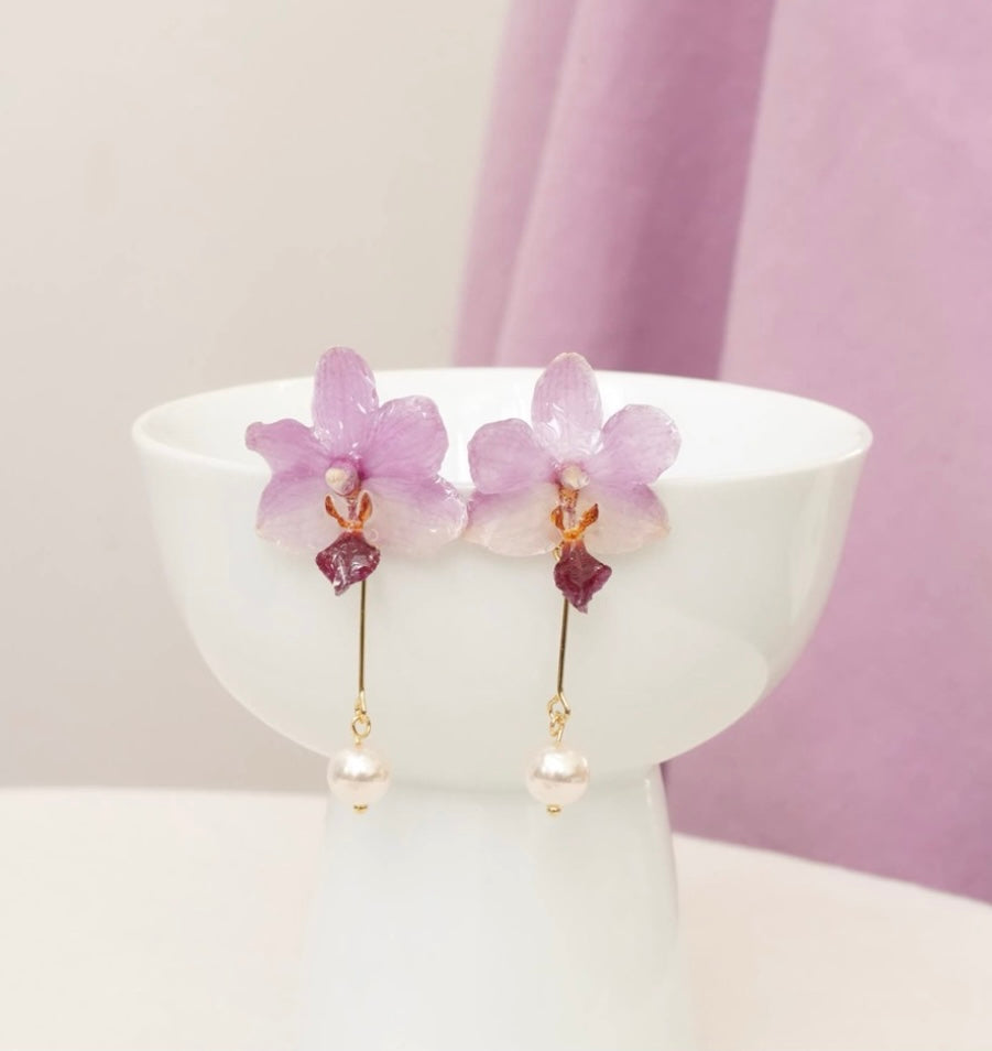 Lavender purple orchid earrings with resin petals and soft pink styling by Terra Decode