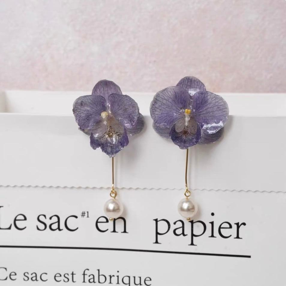 Lavender purple orchid pearl drop earrings with resin petals on printed paper by Terra Decode
