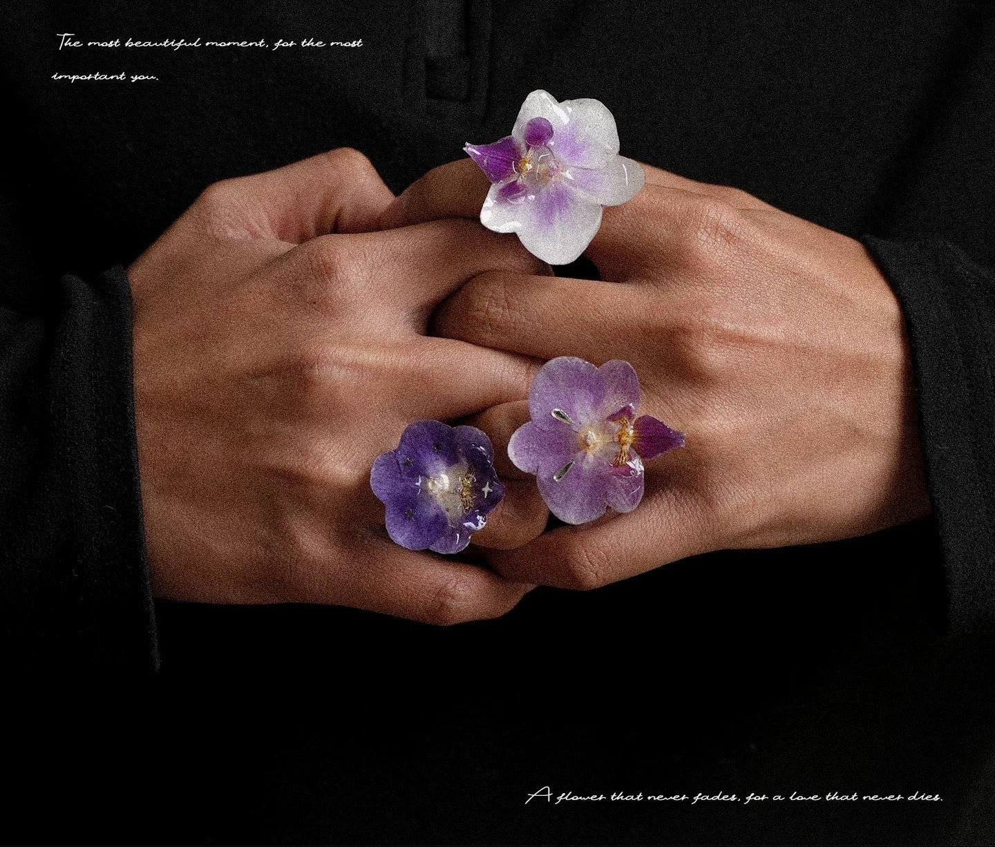 Orchid statement ring variations with soft purple resin petals worn against black fabric by Terra Decode