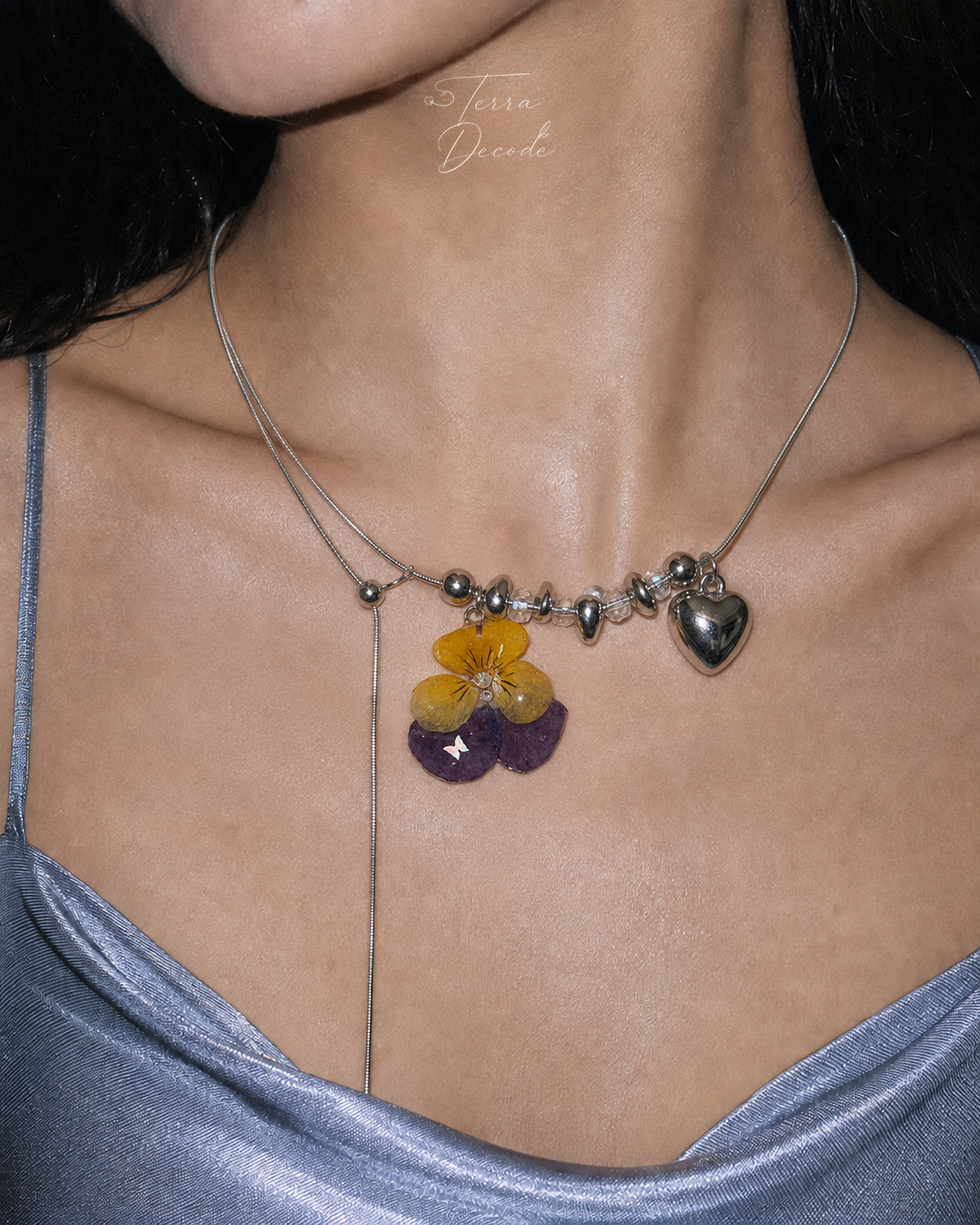 Model wearing the Pansy Heart Adjustable Lariat Necklace from Terra Decode's Flowers in Y2K collection