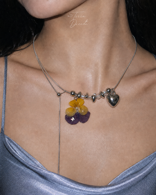 Model wearing the Pansy Heart Adjustable Lariat Necklace from Terra Decode's Flowers in Y2K collection