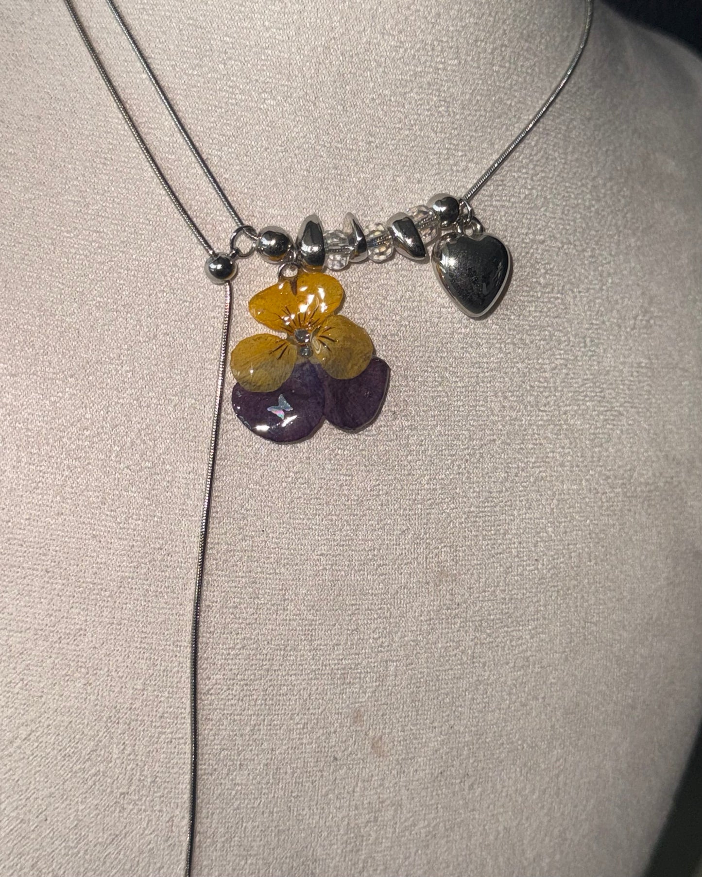 Additional view of pansy lariat showing the long adjustable chain drop