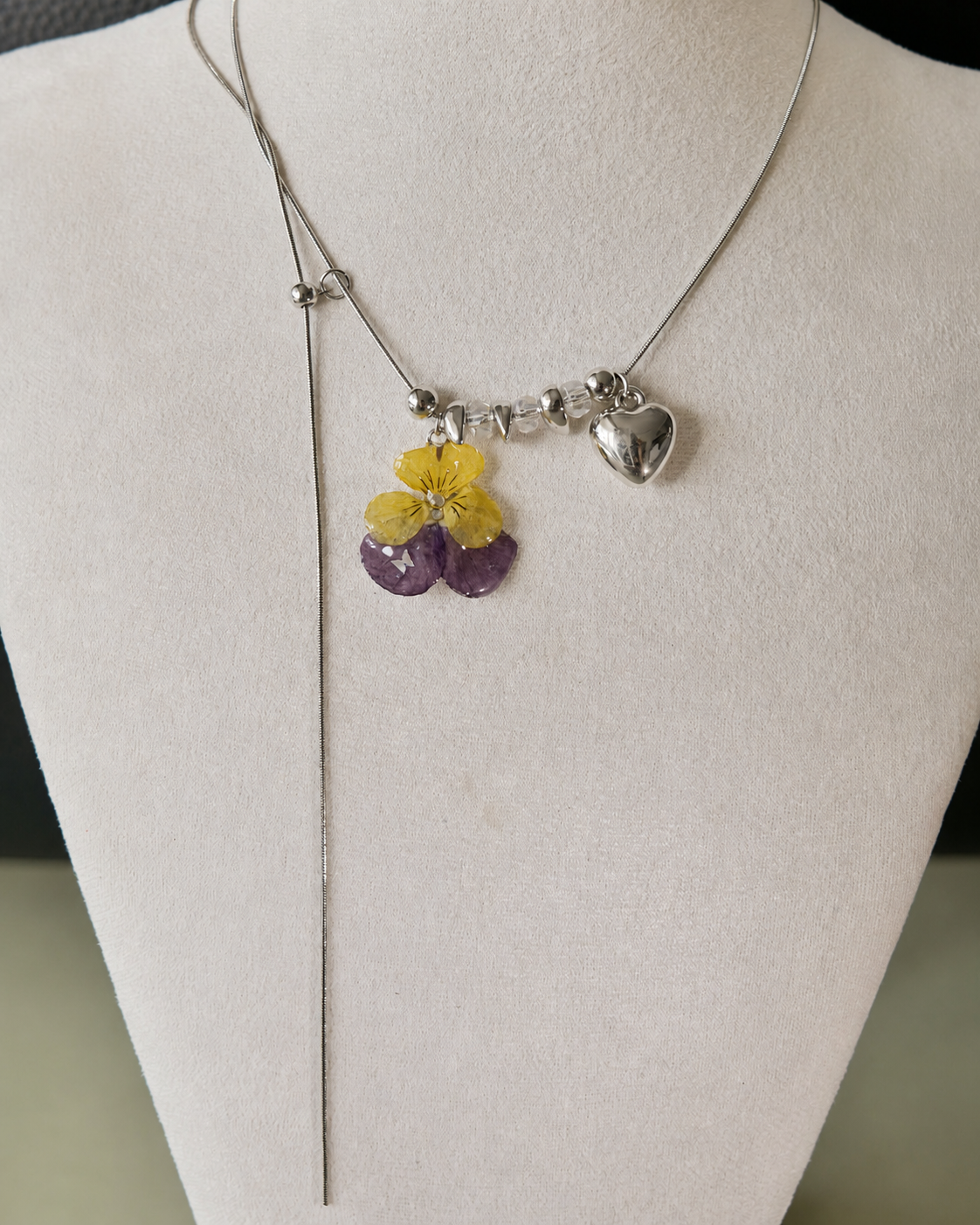 Front display view of the Pansy Heart Adjustable Lariat Necklace with preserved yellow-and-purple pansy, Pansy Heart Adjustable Lariat Necklace botanical jewellery by Terra Decode