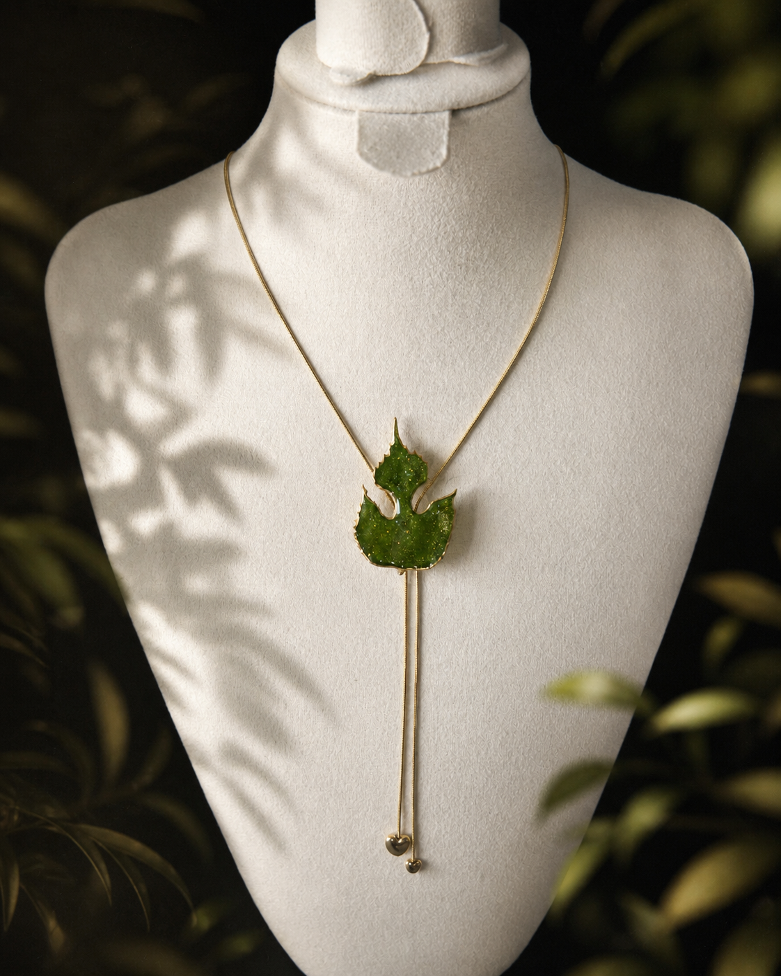 Left angled view of preserved paper mulberry leaves and gold-toned lariat, Paper Mulberry Double-Heart Lariat Necklace botanical jewellery by Terra Decode