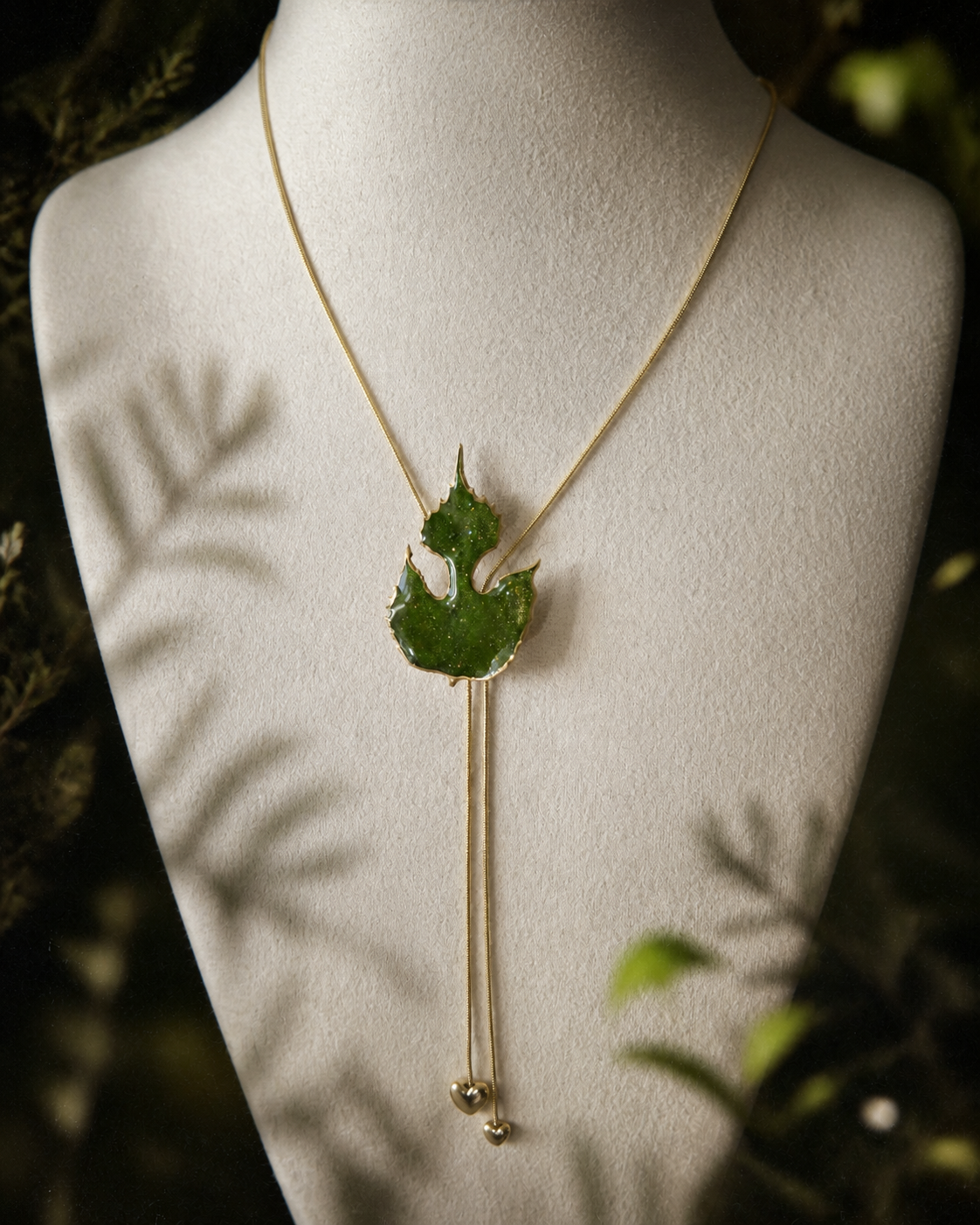 Detail of the two slender gold-toned chains below the leaf pendant, Paper Mulberry Double-Heart Lariat Necklace botanical jewellery by Terra Decode