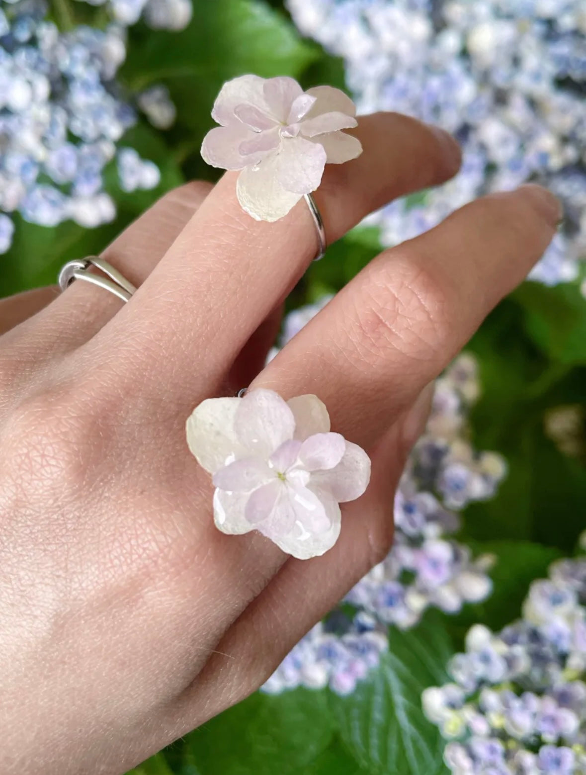 Cream white hydrangea ring variations with small resin flowers worn with garden flowers by Terra Decode