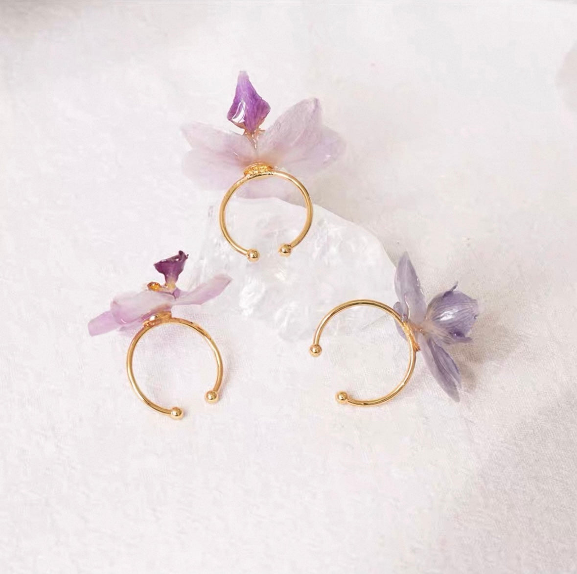 Lavender purple orchid rings with resin petals and gold-tone adjustable bands by Terra Decode