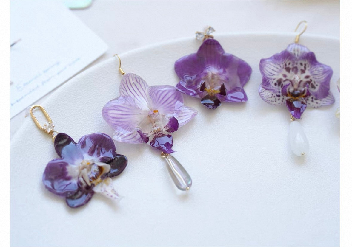 Preserved orchid drop earring variations with purple and cream resin petals by Terra Decode