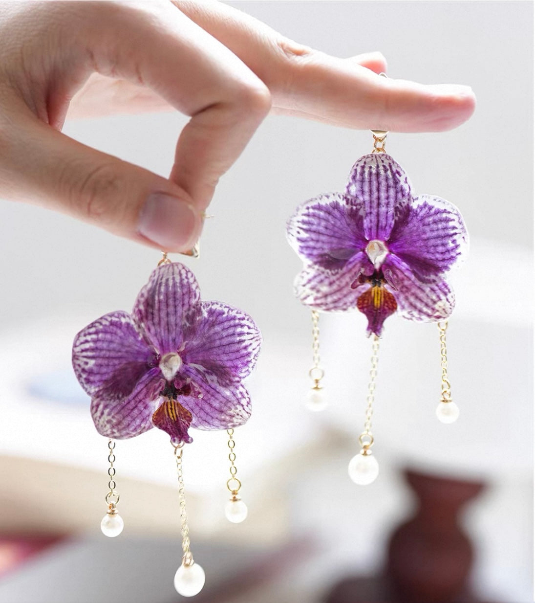 Purple orchid earrings with resin petals and pearl-like drops by Terra Decode
