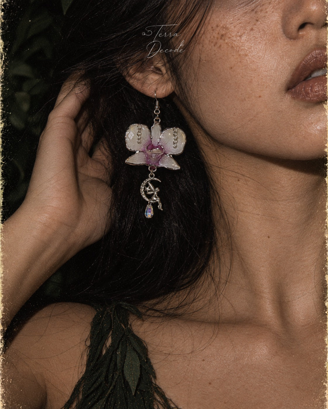 SERAPHIEL Dendrobium Angel Charm Colour-Shift Earrings worn by a model | Terra Decode