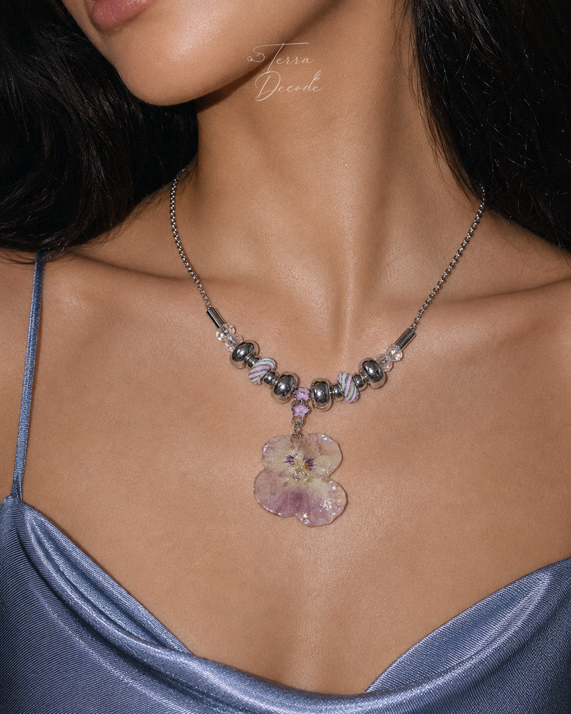 Model wearing the Smoky Pink Pansy Beaded Necklace from Terra Decode's Flowers in Y2K collection