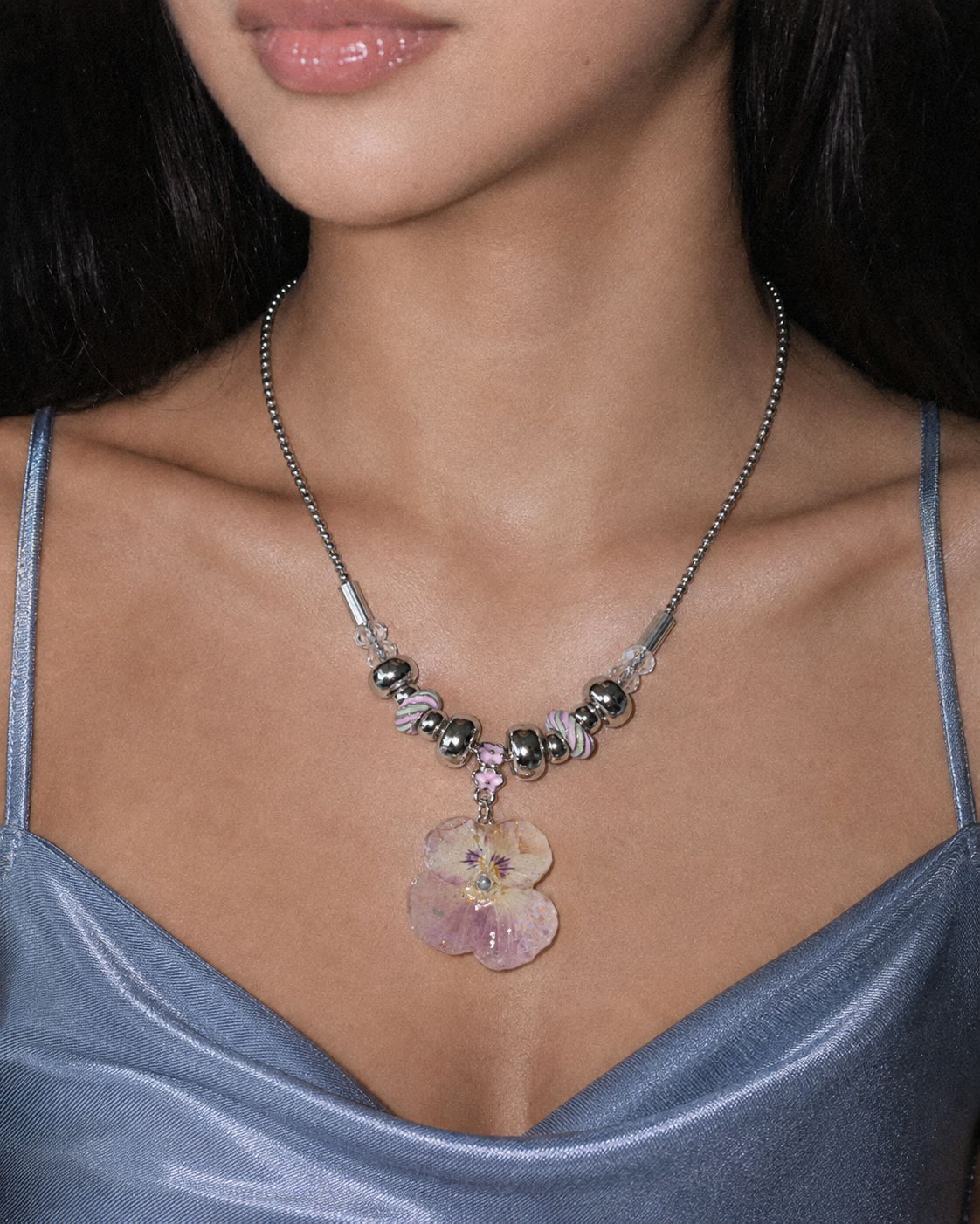 Model wearing the Smoky Pink Pansy Beaded Necklace by Terra Decode