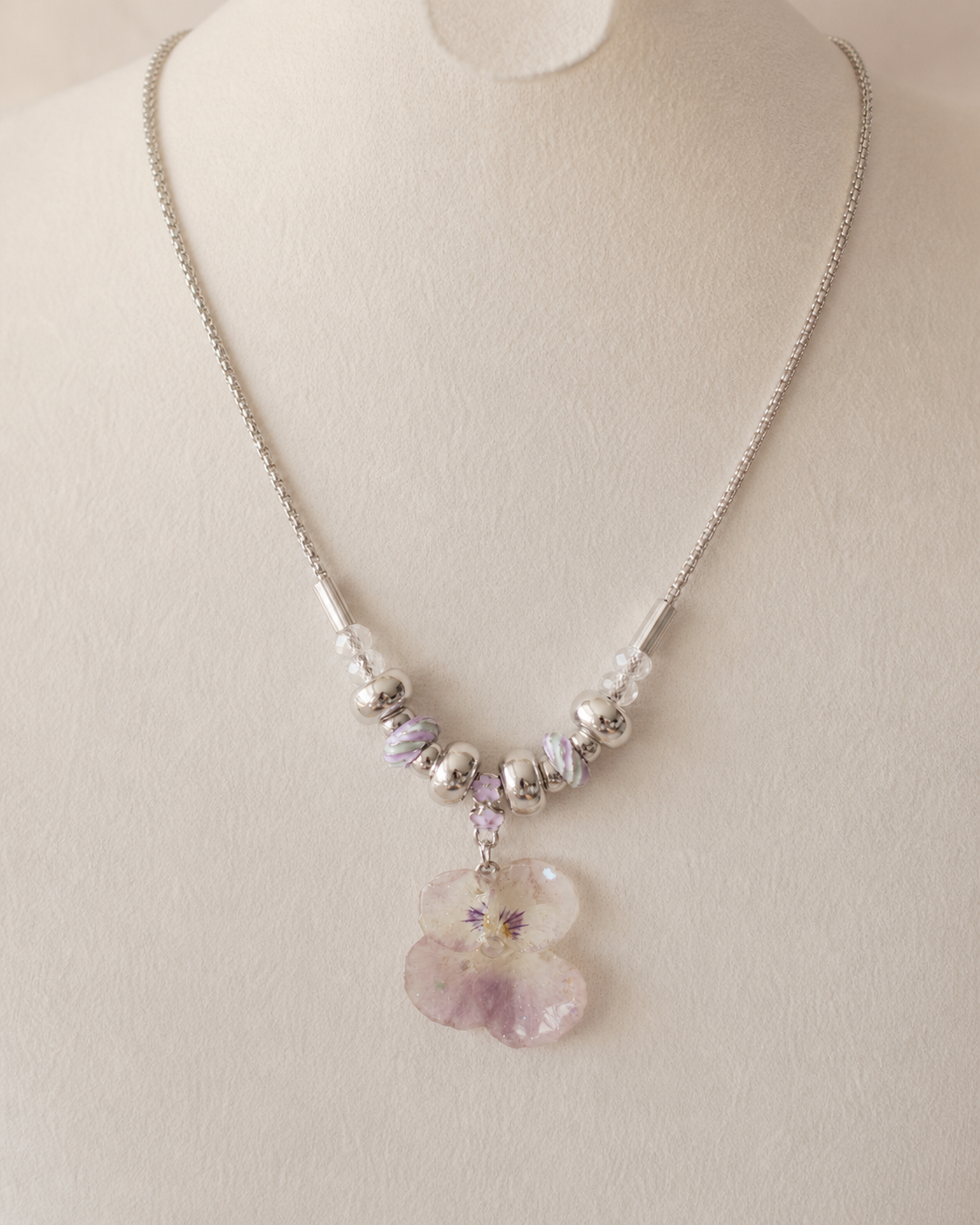 Front display view of the Smoky Pink Pansy Beaded Necklace with preserved flower pendant, Smoky Pink Pansy Beaded Necklace botanical jewellery by Terra Decode