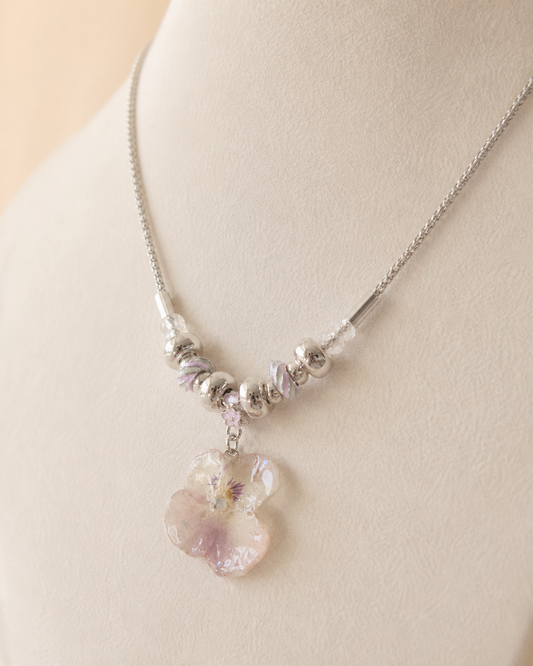 Close view of the real smoky-pink pansy preserved in clear resin, Smoky Pink Pansy Beaded Necklace botanical jewellery by Terra Decode