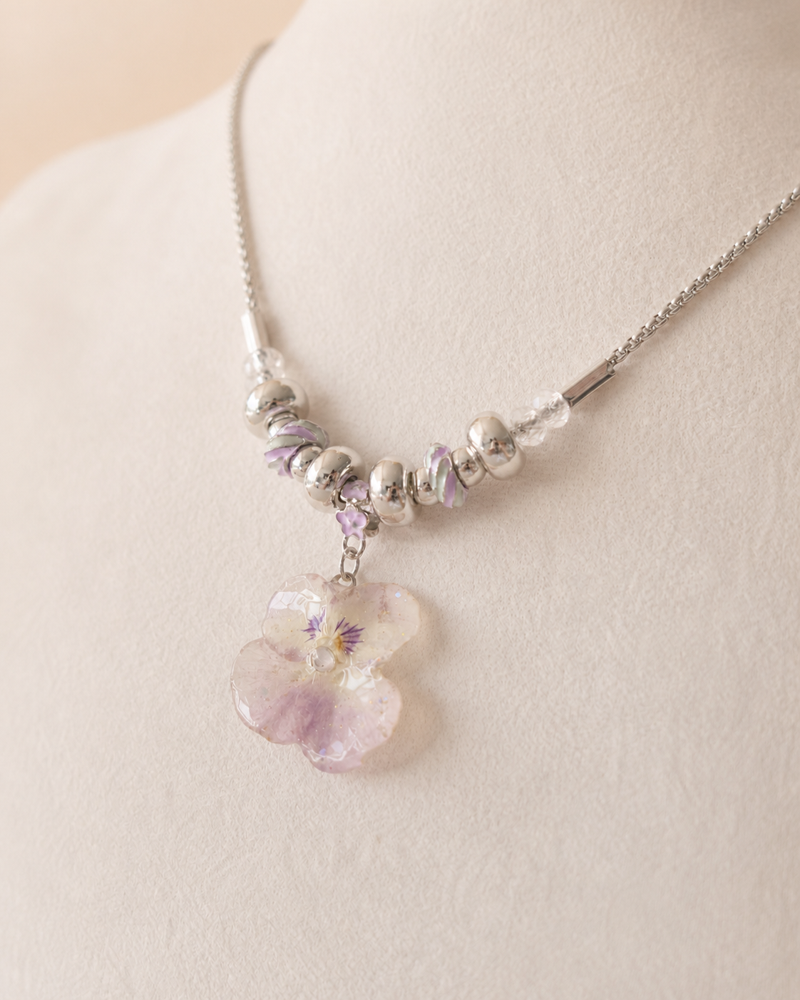 Alternate angle showing the pansy pendant and pink-lilac swirl beads, Smoky Pink Pansy Beaded Necklace botanical jewellery by Terra Decode
