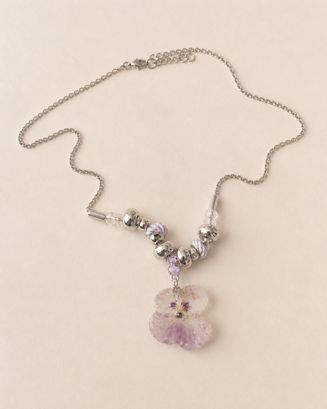 Full necklace view showing the preserved pansy pendant and pastel bead arrangement, Smoky Pink Pansy Beaded Necklace botanical jewellery by Terra Decode