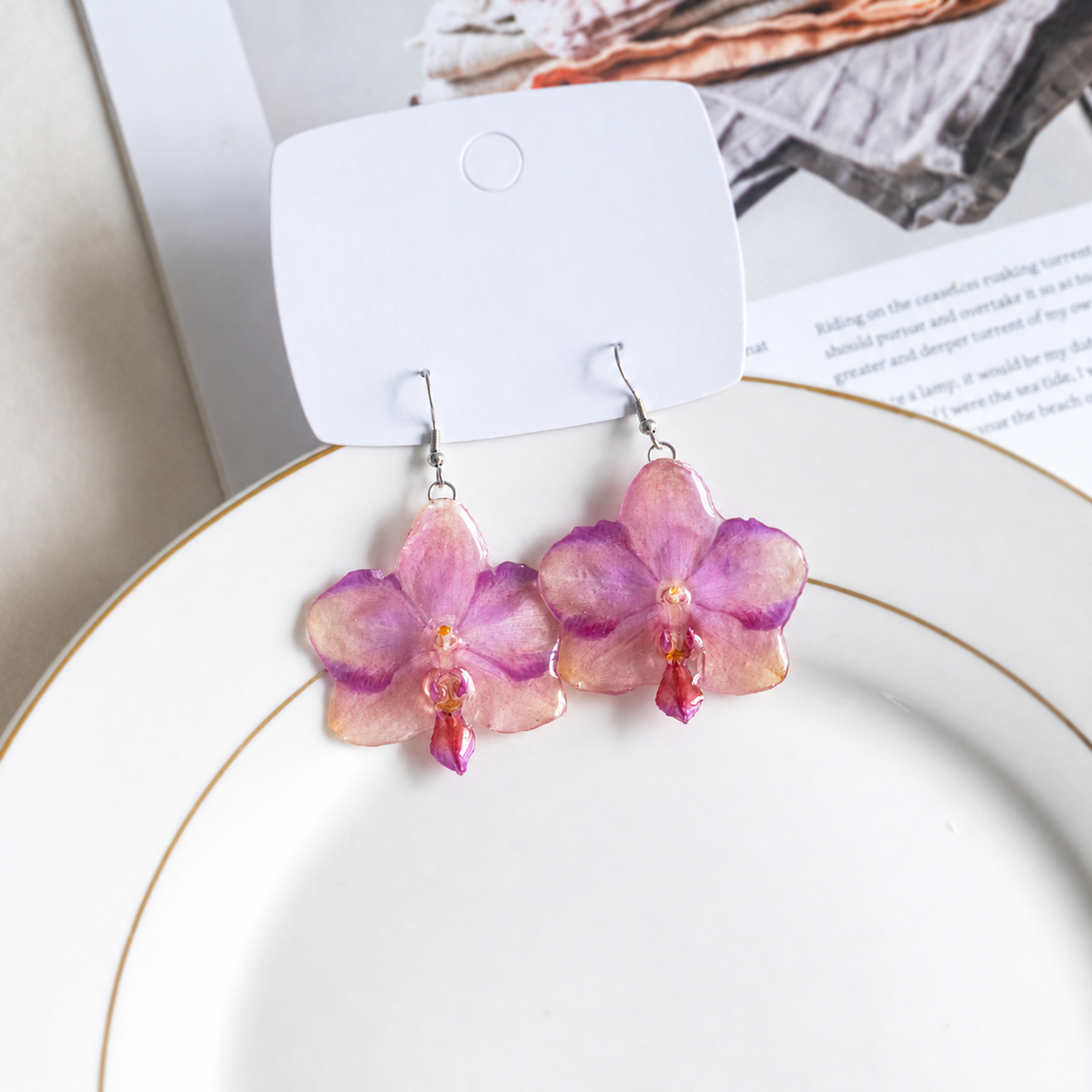 Pair of preserved Phalaenopsis orchid earrings displayed on a blank jewellery card, Sunset Pink Phalaenopsis Drop Earrings botanical jewellery by Terra Decode
