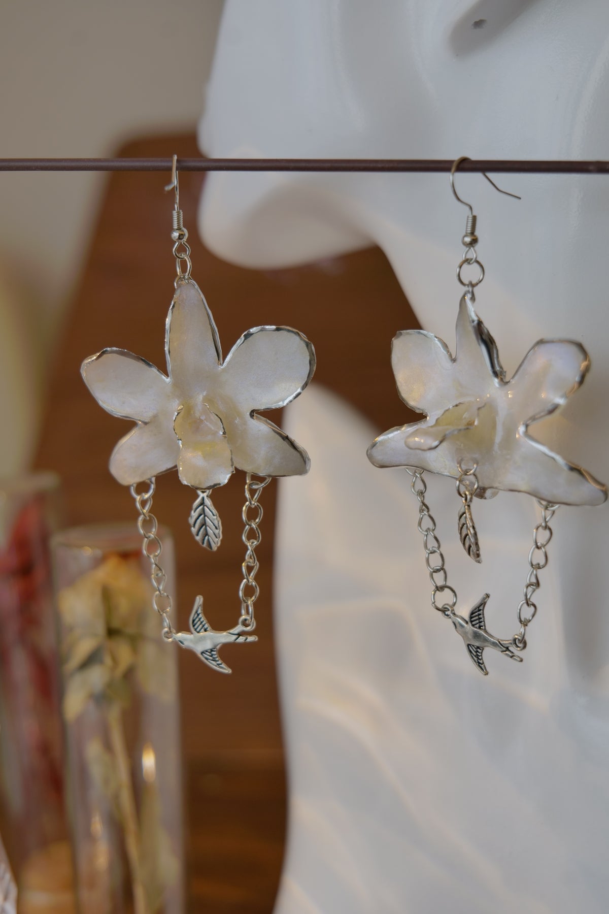 ALBION — White Dendrobium Bird Dangle Earrings by Terra Decode — product photograph 3 showing the handmade botanical earrings.